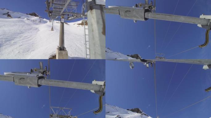 坐在瑞士阿尔卑斯山的升降椅上。电缆和椅子连接的视图。