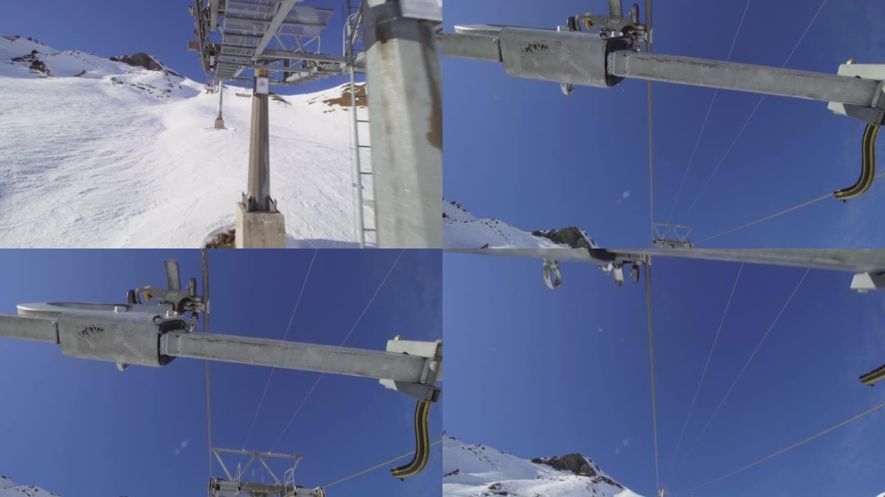 坐在瑞士阿尔卑斯山的升降椅上。电缆和椅子连接的视图。