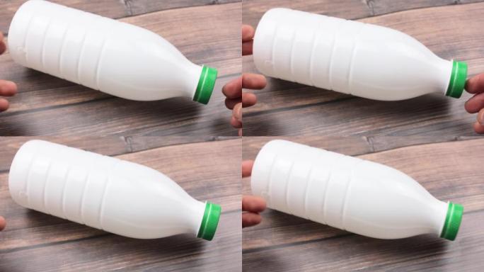 White plastic bottle on a wooden table. White bott