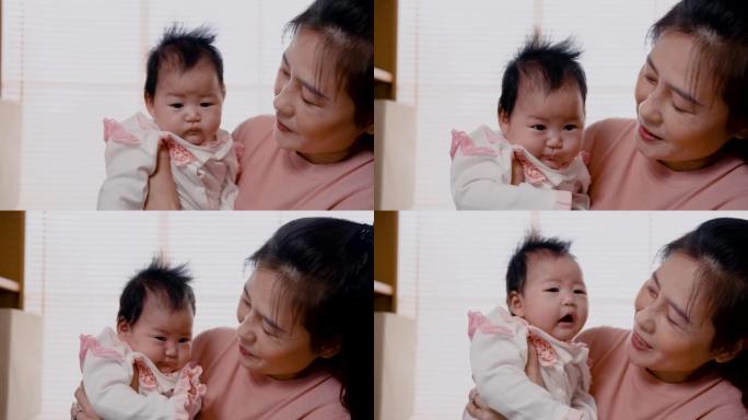4K，亚洲妇女抱着她3个月大的女婴，在卧室里聊着让宝宝下午睡觉的好处。单身母亲正在照顾新生婴儿。