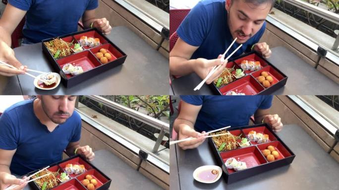 男人用筷子吃寿司
