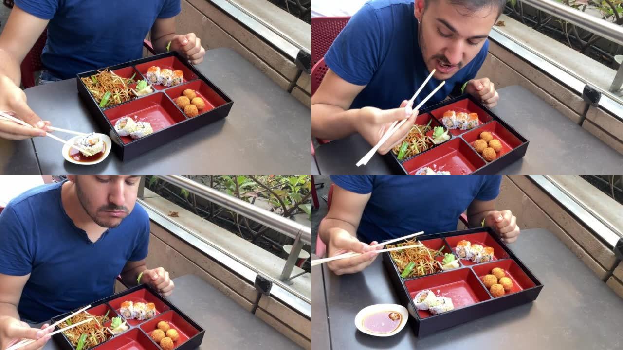 男人用筷子吃寿司