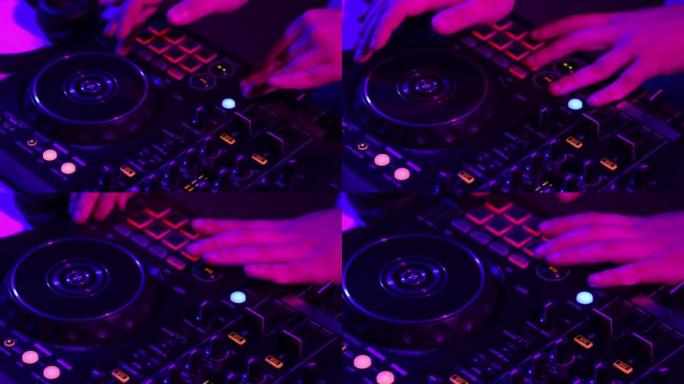 dj制造商的手在霓虹灯下用专业调音台在夜总会派对上发声的特写镜头。现代派对风格。节奏很深。