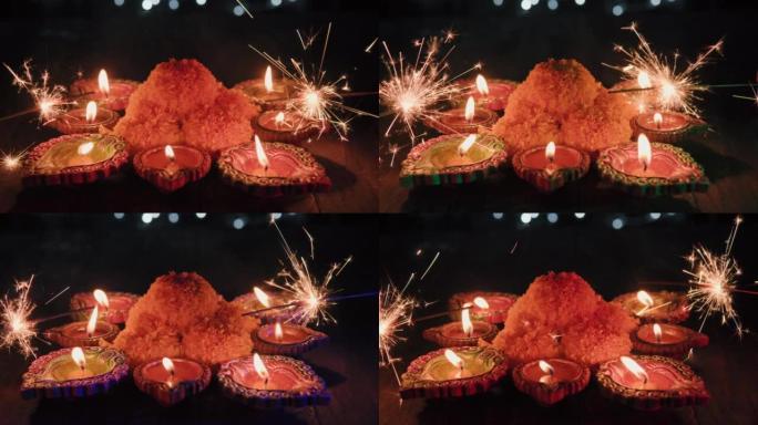 五颜六色的排灯节油灯，屠妖节油灯以美丽的形式点亮，中间有花朵，背景有不同的五颜六色的花朵，油灯闪闪发