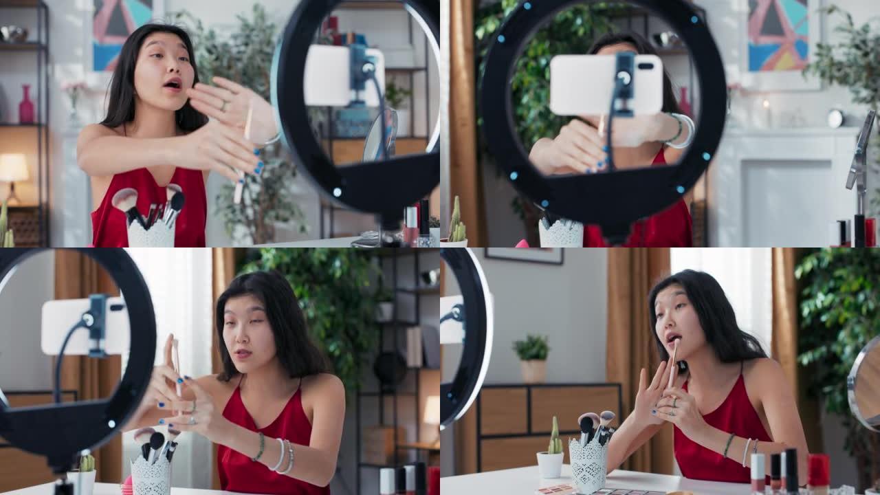 Beauty influencer用环形光电话记录vlog。女孩谈论眼妆刷。亚洲美女流光主持人现场直