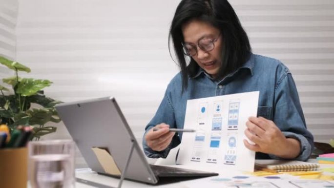 亚洲女性ux ui开发者在线会议视频电话与同事关于移动应用原型线框
