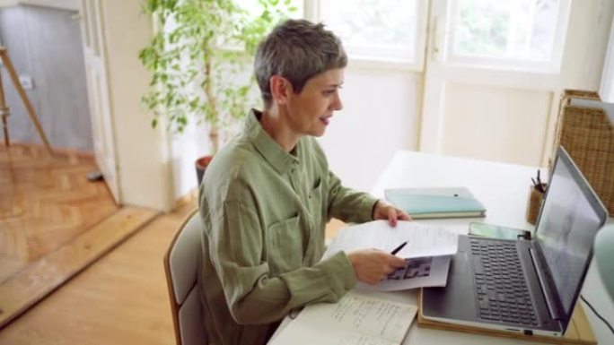 Businesswoman doing a video call at home using lap