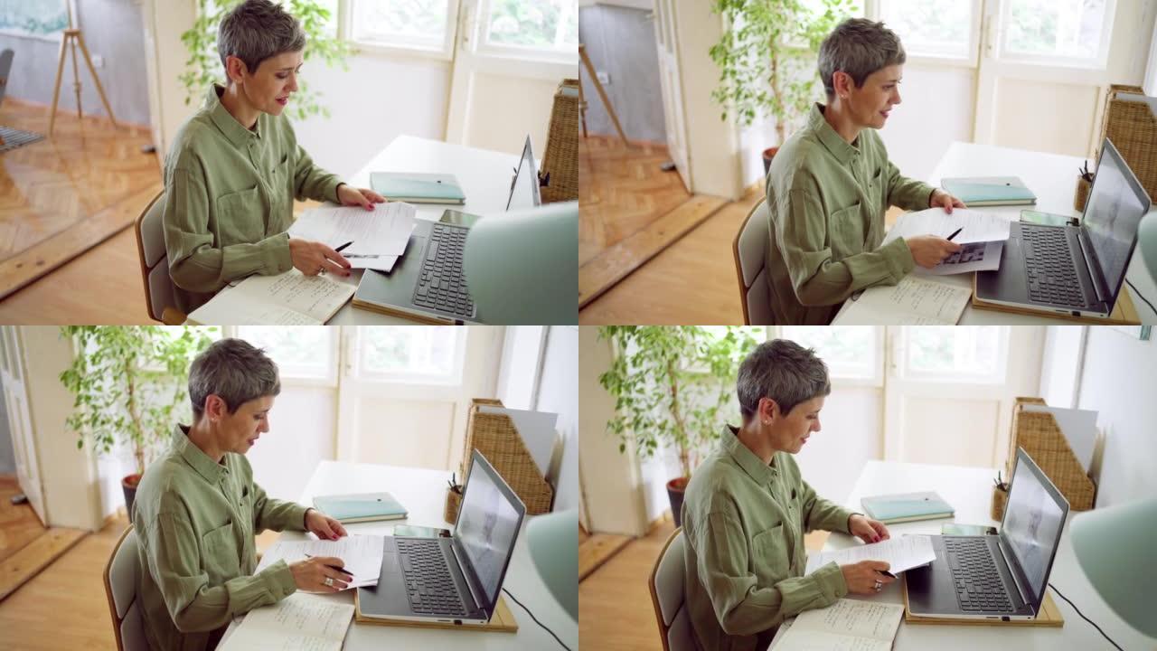 Businesswoman doing a video call at home using lap