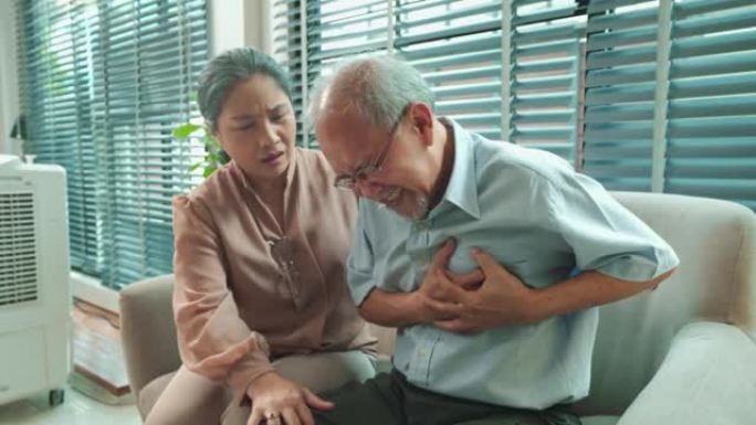 退休的亚洲老人因心脏病而胸部疼痛的肖像，老年妇女或他的妻子担心自己的疾病。