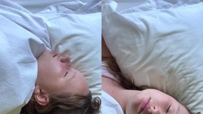 垂直视频雀斑的少女在床上睡着了她的眼睛闭上，她陷入了梦境，可以用于广告床单或任何保健品