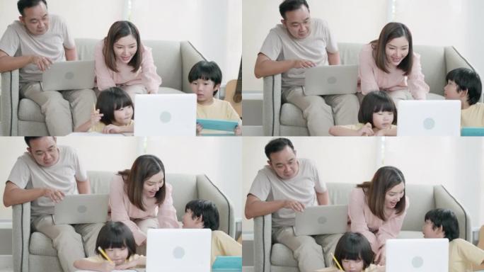 亚洲的父亲和母亲照顾，教导和帮助儿子在笔记本电脑上使用想象力并学习社交媒体知识，在家里的客厅享受假期