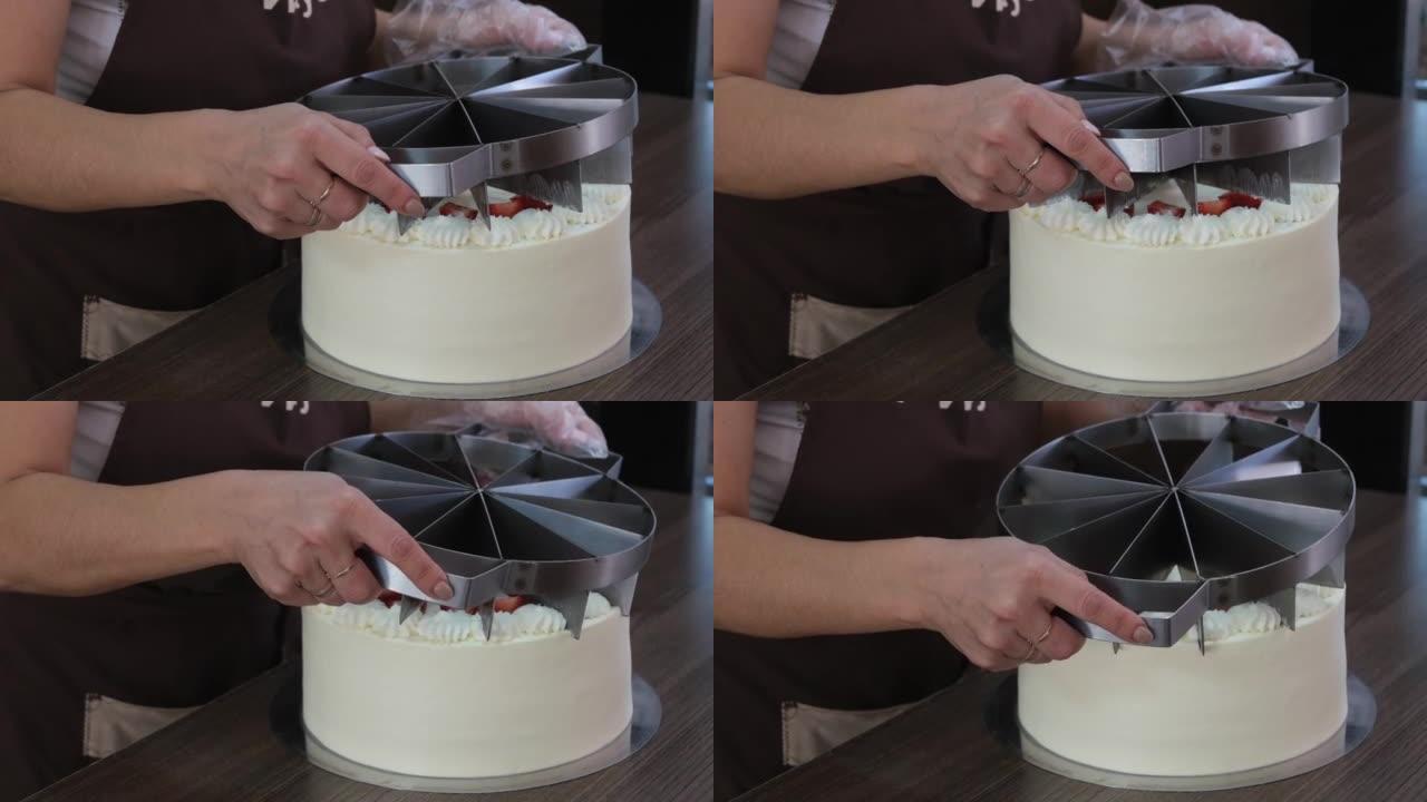 女性的手用大刀切蛋糕。女人糖果用特殊工具勾勒出蛋糕上的碎片。