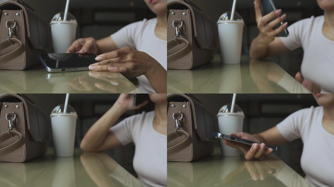 坐在咖啡店里的女人拿起她的智能手机开始说话。