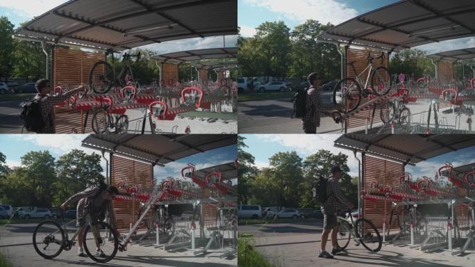 男子将自行车停在德国慕尼黑的两层自行车停车场。双层自行车停车场。骑自行车的人将自行车停在错层自行车停