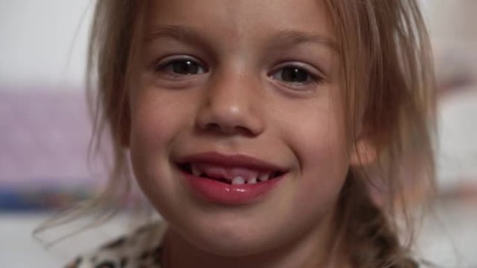 女孩的特写微笑。一个6-7岁的漂亮小女孩掉了乳牙。乳牙脱落，恒牙更换。快乐微笑的孩子是牙科。白牙脸。