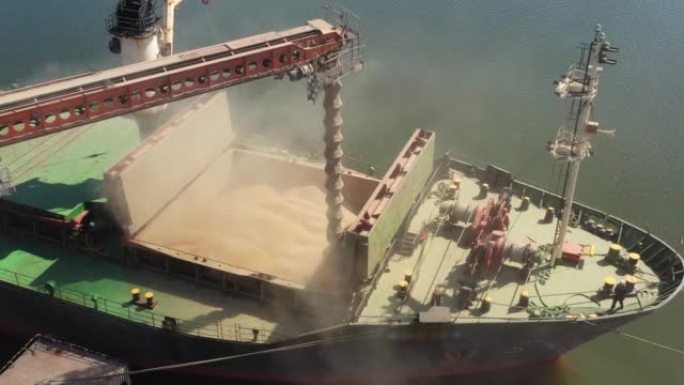 Aerial of wheat loading to bulker ship cargo hold 