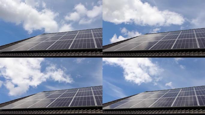 太阳能电池板上的云层和天空在住宅屋顶上产生清洁能源的时间流逝。