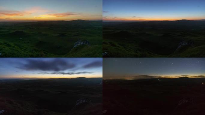英国威尔士布雷肯比肯斯国家公园的黑山，白天到黑夜的时间在丘陵景观上流逝，美丽的日落和云在星星前移动