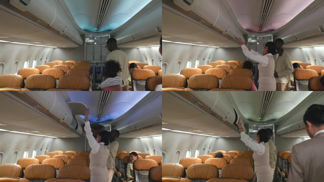 空中人质帮助乘客商人将行李放在飞机的顶部架子或机舱上