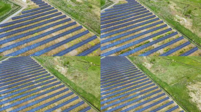 绿地上太阳能发电厂的鸟瞰图。带有用于生产清洁生态能源的面板的电力农场