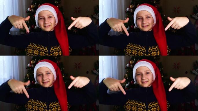 一个穿着冬季毛衣和圣诞老人帽子的十几岁男孩用手指朝下，注意下面的东西