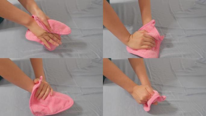 一个女人用粉红色的小毛巾擦手的特写镜头