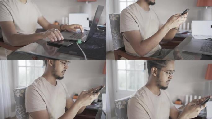 Young man texting on his phone while working remot