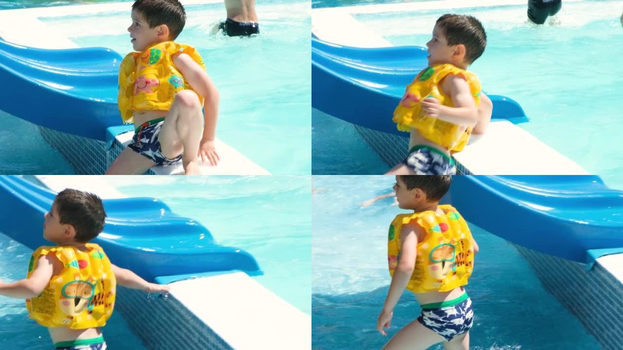 一个穿着充气黄色背心的5岁男孩在水上公园的游泳池里玩耍。