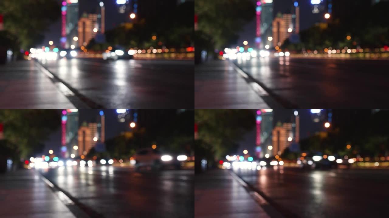 散焦夜路灯实时4k镜头在上海。夜城路散焦前灯和尾灯。模糊的灯光道路交通运输，模糊的夜间城市交通。夜间