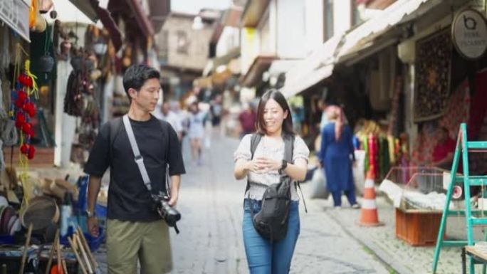 Young tourist couple walking in historical town an