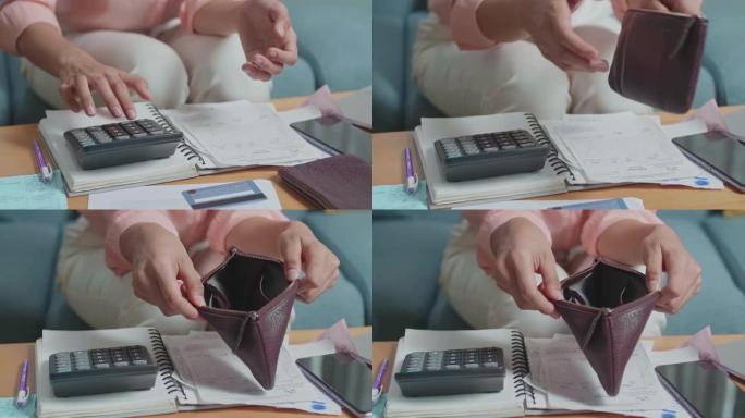 打开钱包检查钱之前，女人的手用计算器计算钱的特写