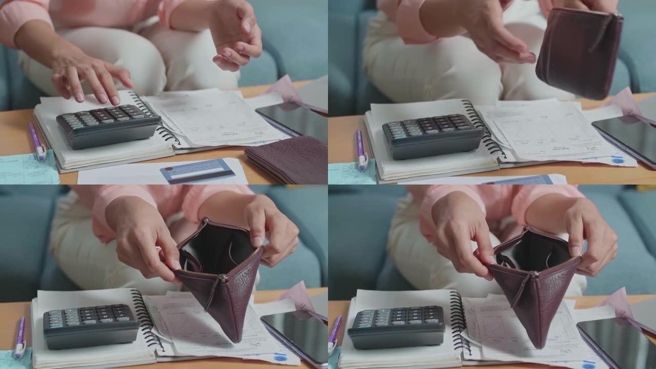 打开钱包检查钱之前，女人的手用计算器计算钱的特写