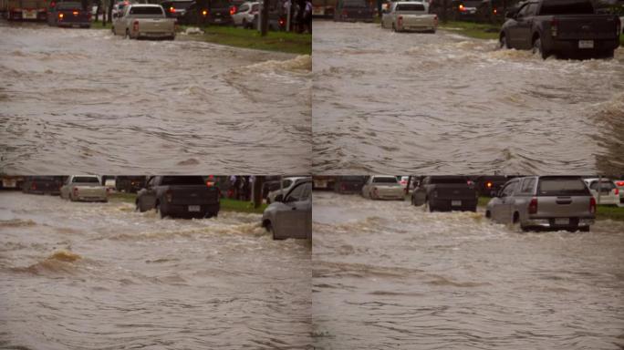 暴雨过后，汽车在洪水泛滥的道路上行驶。