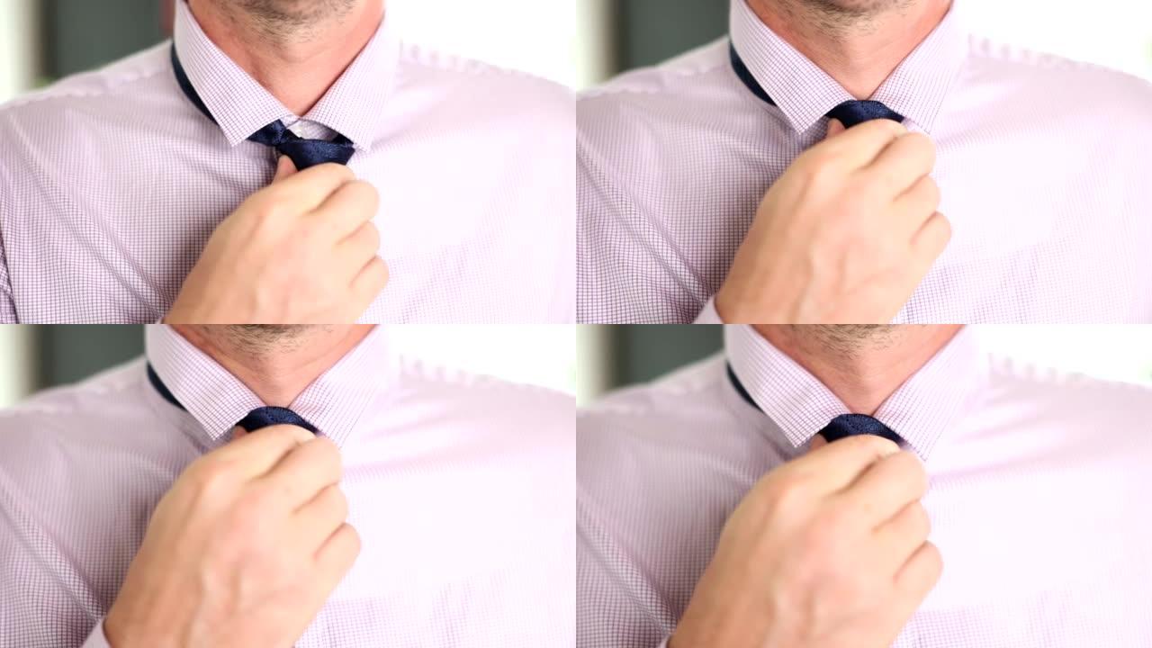 男子在衬衫上系上蓝色领带特写4k电影慢动作