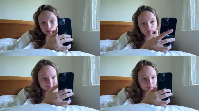 一个穿着白衬衫的女孩一个少年躺在白色的床上，手里拿着黑色的iPhone 13她看着屏幕平静地举起双手