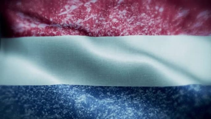 4K暴风雪/雪在荷兰国旗股票视频。荷兰的国旗。旋转/旋转的冰晶。雪花掠过荷兰国旗。