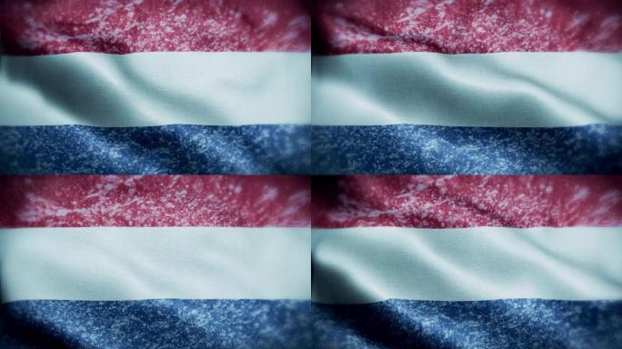 4K暴风雪/雪在荷兰国旗股票视频。荷兰的国旗。旋转/旋转的冰晶。雪花掠过荷兰国旗。