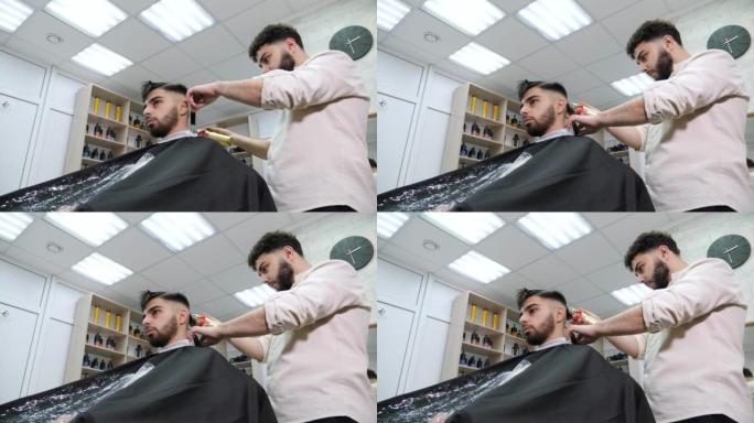 理发师用电动剃刀剪掉客户的头发。