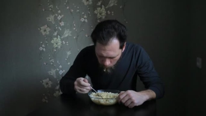 bearded man eating instant noodles.