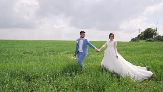 Just married couple walking in nature, hold hands 