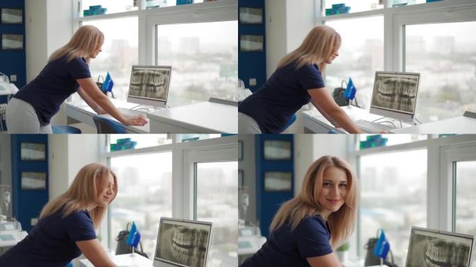 美丽的女牙医在计算机监视器屏幕上检查人类下巴的图片