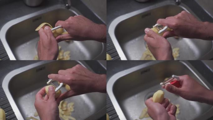 丈夫用清洗蔬菜和做晚餐的工具剥土豆。健康食品主题，男人用刀在厨房水槽上剥生土豆。农场的有机温室蔬菜。