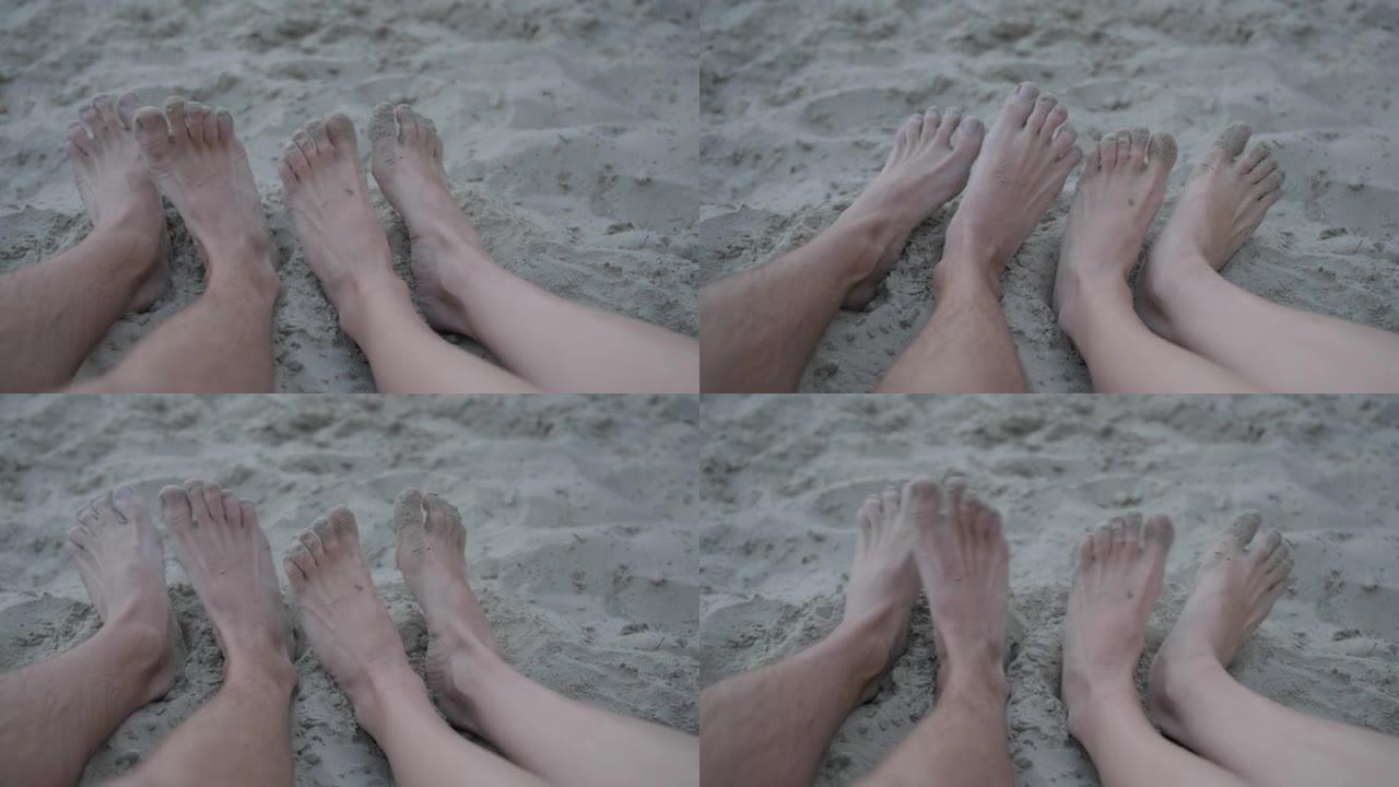 两对有趣的男女腿在海滩上移动