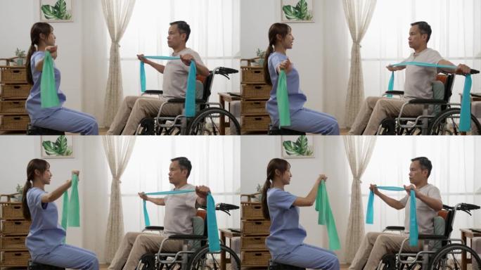 亚洲老年男性轮椅使用者的慢动作在护士的支持下进行理疗阻力训练。他们在家里把弹力带拉在一起