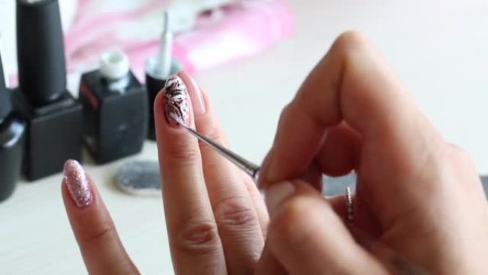 A woman applies nail polish. Does a manicure. Next