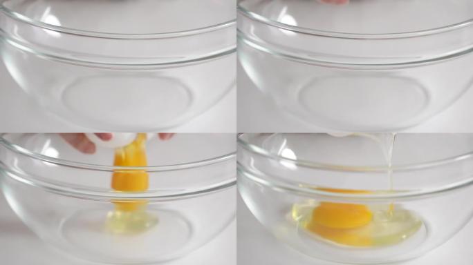 将鸡蛋直接打入家庭厨房的玻璃碗中制作蛋糕。