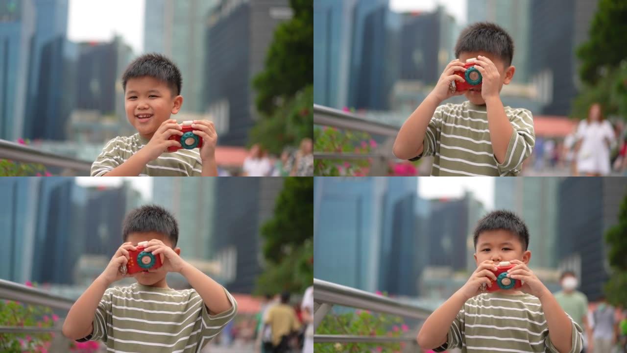 亚洲男孩带着相机在新加坡巡回演出