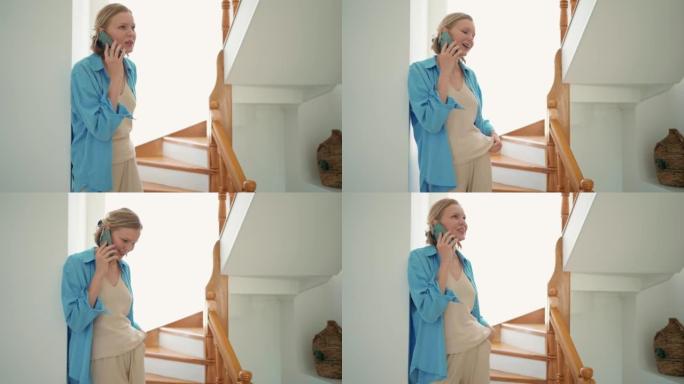 Smiling woman talking by phone indoors at home