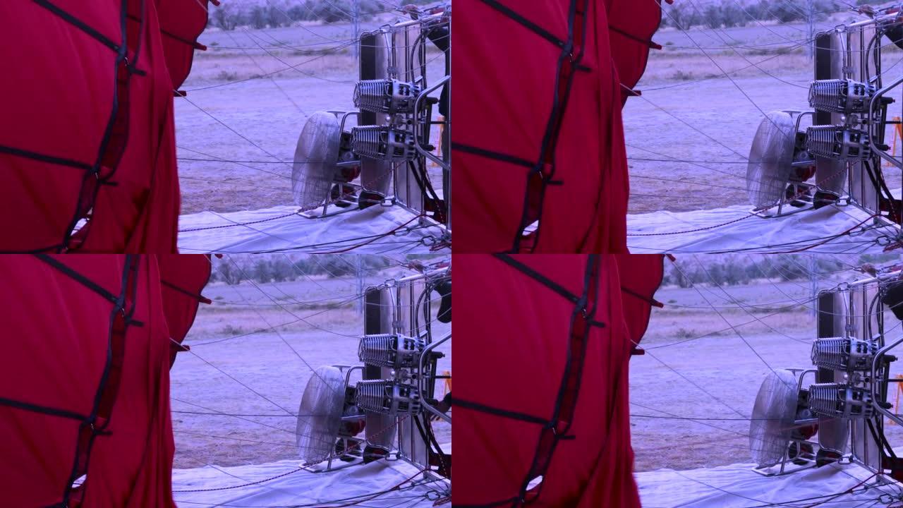 红色的充气气球从里面热空气，然后在黎明前的清晨在天空中飞行，旅游路线