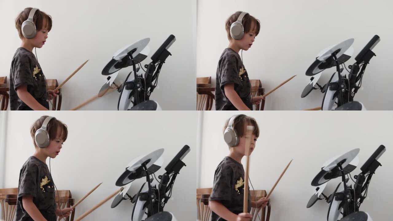 小男孩在家客厅练习演奏电子乐器鼓
